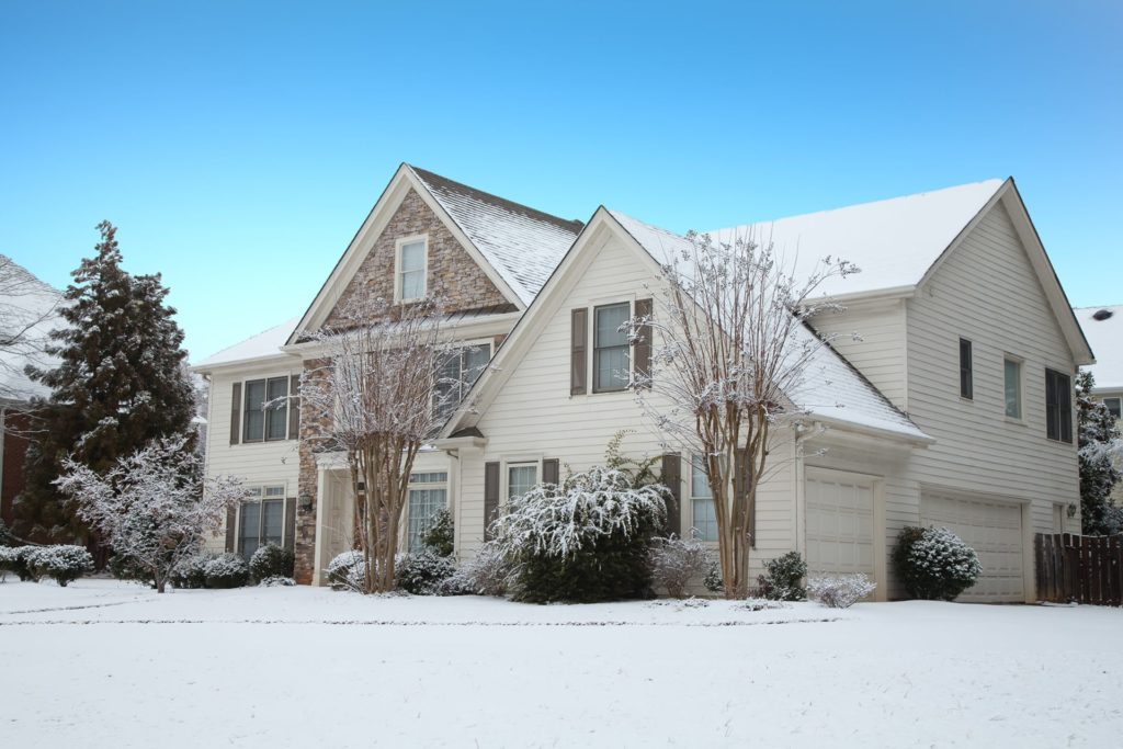 snow covered home with replacement windows