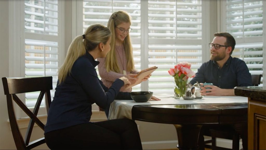 family sitting in front of energy-efficient windows